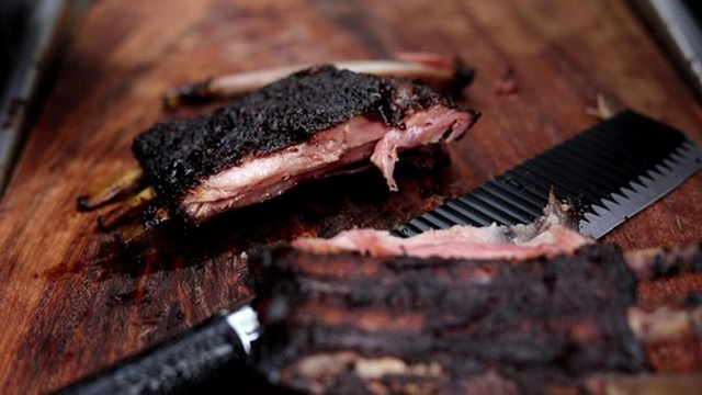 Smoked rib rack sliced on a board